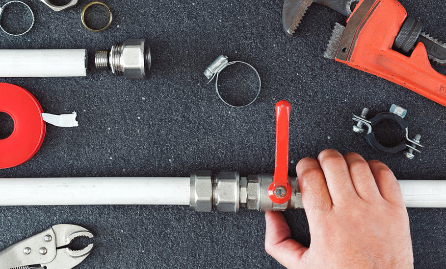 A Plumber Holding Faucet Tools for Repair in Bathurst, NSW