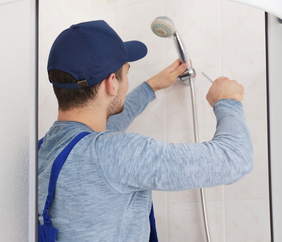 Plumber Working in Shower Stall in Oberon, NSW