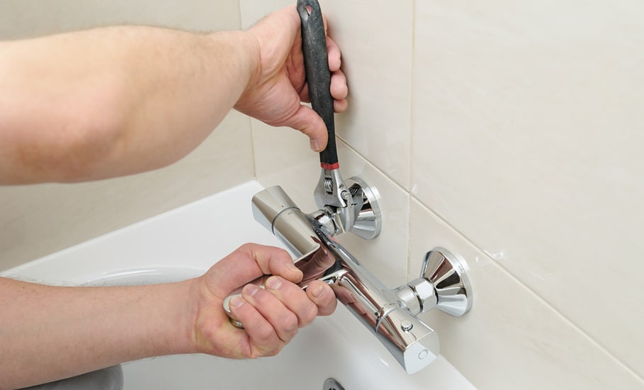 Man's Hands Are Fixing Bath Tap Into Place in Bathurst, NSW