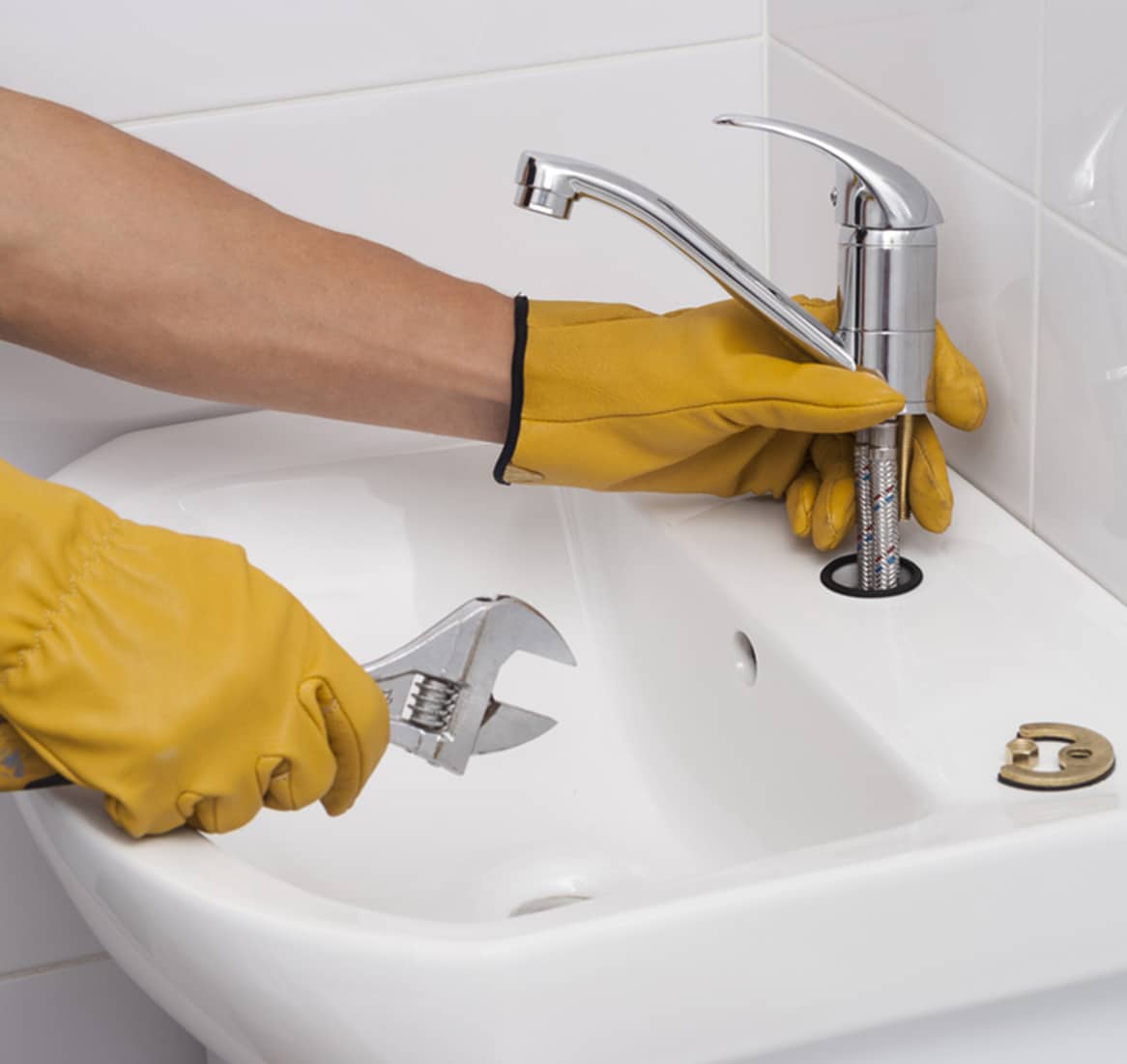 Plumber Installs a New Faucet for a Sink - Emergency Plumbing Services In Lithgow, NSW