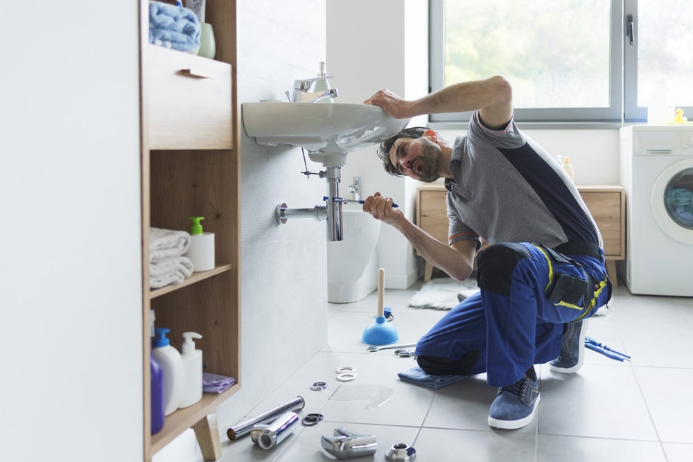 A Professional Plumber Unclogging Slow Drain