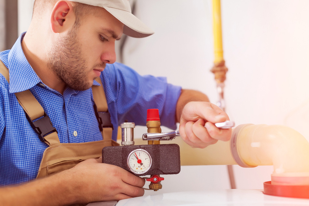 Plumber Servicing Gas Boiler