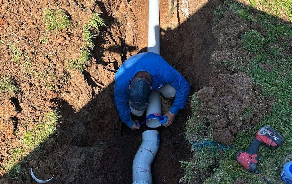 Plumber Working On Plumbing Pipes