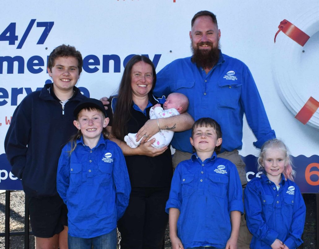 Family in Company Uniforms Smiling - Emergency Plumbing Services In Orange, NSW